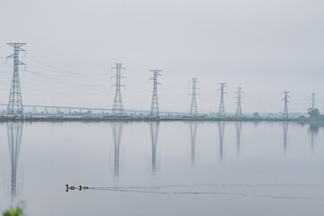 Power lines reflecting in water, city park, industrial, power theme, textured backgrounds.