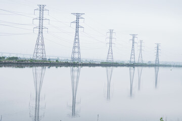 Power lines reflecting in water, city park, industrial, power theme, textured backgrounds.