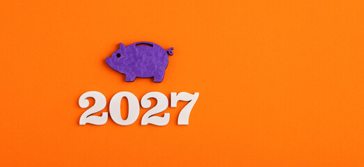 Piggy bank, coins and year 2027 - Savings and investment