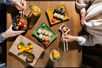woman eating sushi in restaurant
