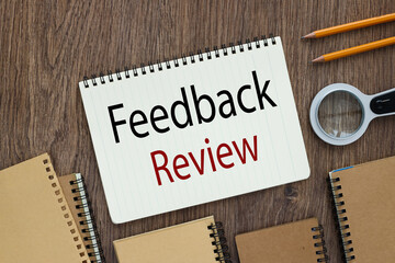 FEEDBACK REVIEW open notepad with text near many notepads and magnifier