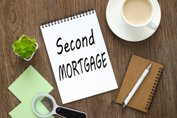 second mortgage. notepad on a wooden background with text