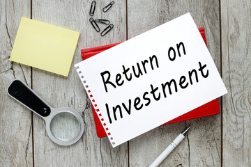 Roi Return On Investment Analysis Finance Concept. sheet of paper with text on a red notepad
