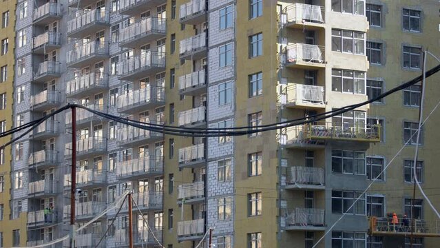 Electrical cable and new high-rise skyscraper building. New high construction.