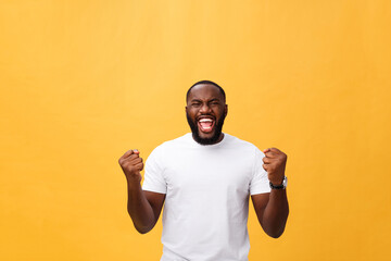 Handsome young Afro-American man employee feeling excited, gesturing actively, keeping fists...