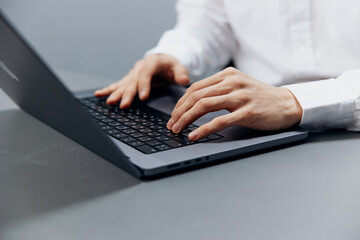 worker sits at a desk in front of a laptop Internet isolated background