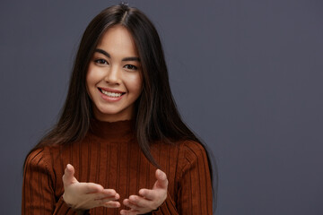 young woman hand gestures brown sweater fashion isolated background