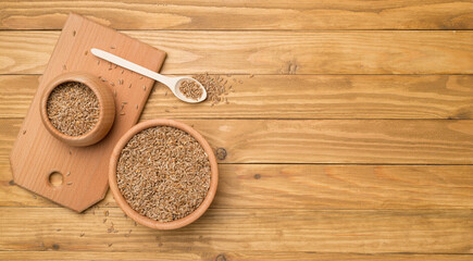 Bowls with wholegrain spelt farro on wooden background. Top view