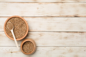 Wholegrain spelt farro in bowl on wooden background. Top view