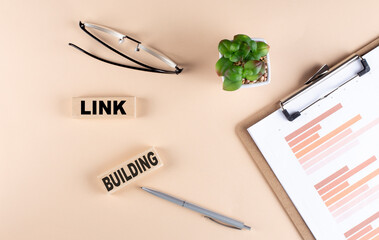LINK BUILDING text on wooden block with chart and glasses, business concept