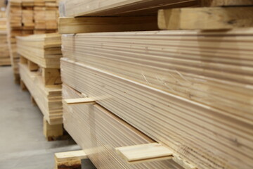 Planed wooden boards stack storage in perspective. Carpentry plant stock