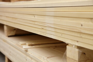 A many planed wooden boards in stack close up in perspective. Sawmill carpentry plant