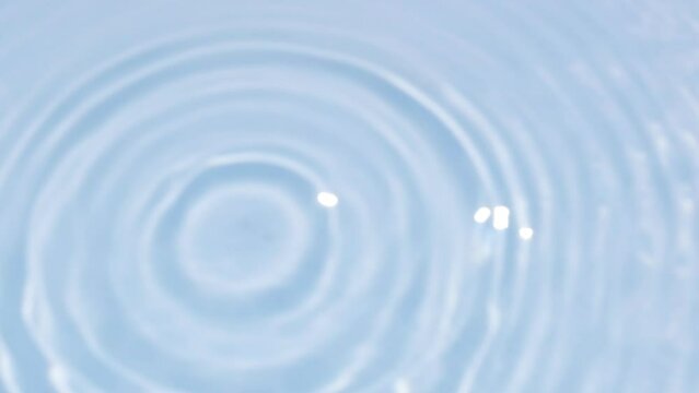 Close up view on Water texture with water circles and drops on the water overlay effect. Organic light gray drop shadow caustic effect with wave refraction of light. Slow motion video banner in blue.