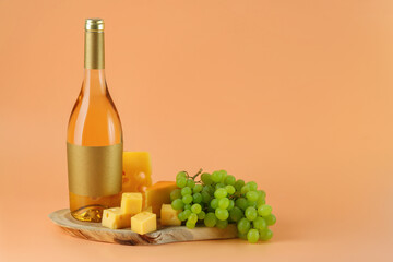 Bottle of wine, cheese slices and grapes on a wooden cutting board. The concept of the Israeli holiday Shavuot