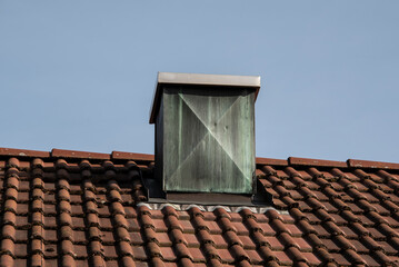 a chimney covered with weathered copper plates