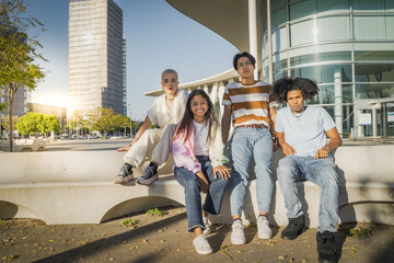 Multiethnic cheerful teenagers in the street looking to the camera. Multicultural diversity.