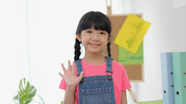 Close up portrait of little girl nice look attractive charming cute lovely cheerful girl after finish school. Multi-ethnic preschool teacher and students classroom. Child education on free time.