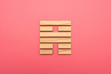 Gene Key 56 wood hexagram i ching on pink background