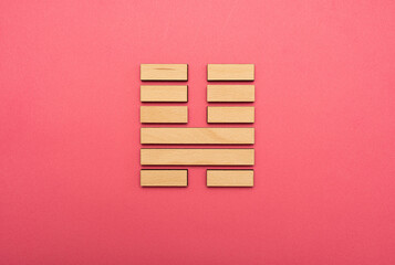 Gene Key 46 wood hexagram i ching on pink background