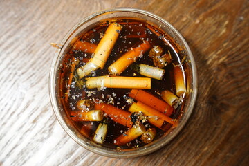 Cigarettes are left in dirty tare water after use.