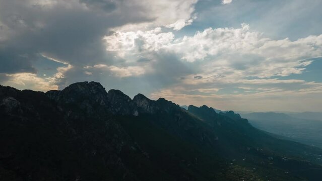 Timelapse in Chipinque, Monterrey city, Mexico, sun rays passing trough clouds over mountains