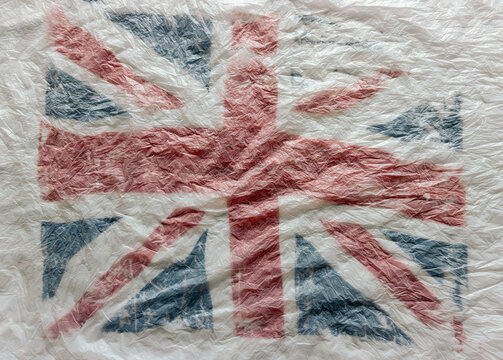 Textured background of the British flag in white, red and blue national colors. blur, defocus.