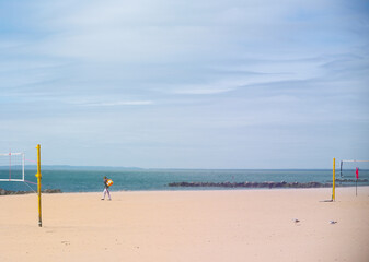 lonely man walking on a beach