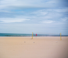 empty volleyball net on a beach in coney island