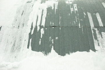 Steel structure in snow. Wall of warehouse after snowstorm. Hedged hangar.