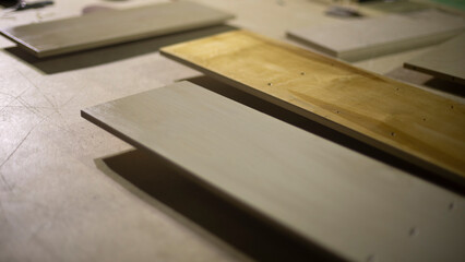 Boards are on table. Materials for creating furniture. Details of carpentry workshop.