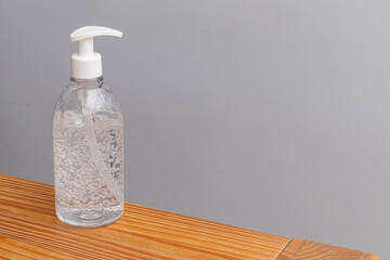 70% hand sanitizer dispenser on a wooden table - copy space