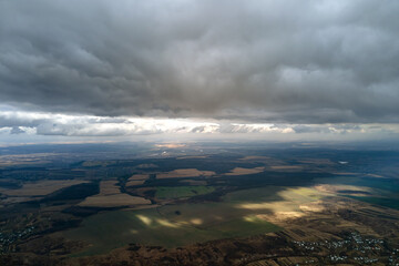Aerial view from high altitude of earth covered with puffy rainy clouds forming before rainstorm