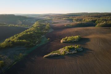 Aerial view of plowed agricultural fields with cultivated fertile soil prepared for planting crops...