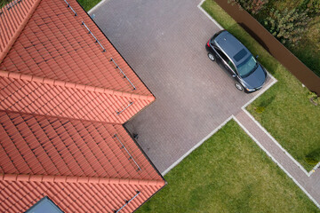 Aerial view of private house with ceramic shingles covered roof top. Investment in real estate...