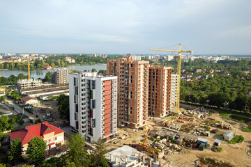 Obraz premium Aerial view of tall residential apartment buildings under construction. Real estate development.