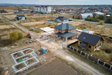 Top down aerial view of building works of new house concrete foundation on construction site