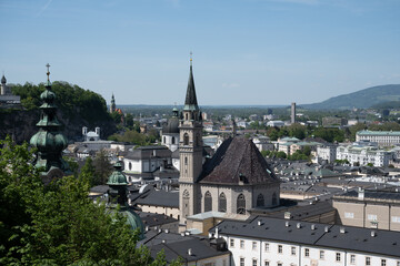 Fototapeta na wymiar View over the old town of Salzburg, Austria, including the Franciscan Church, on a sunny day with a blue sky