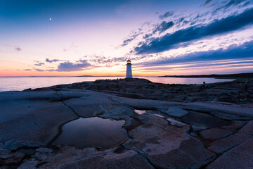 Peggy's Cove Lighthouse during a vibrant sunset. Atlantic Coast, Nova Scotia, Canada. The most visited tourist location in the Atlantic Canada - obrazy, fototapety, plakaty