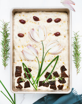 Raw Focaccia Bread Decorated With Flowers Made Of Onions.