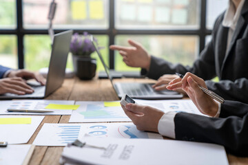 Asian business advisor meeting to analyze and discuss the situation on the financial report in the meeting room. brainstorming, discussing, and analyzing business strategy. Financial advisor concept