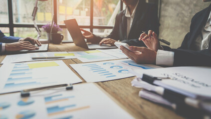 Asian business advisor meeting to analyze and discuss the situation on the financial report in the meeting room. brainstorming, discussing, and analyzing business strategy. Financial advisor concept