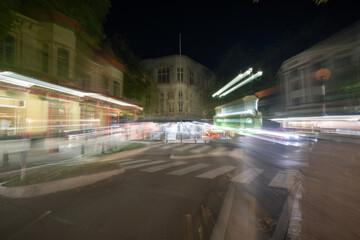 Night time in the city in zoom blur conveying frenetic urban pace of life and background
