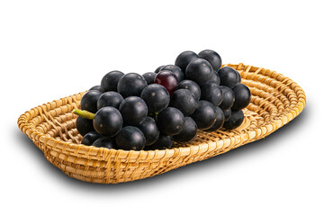 Bunch of ripe black grapes in bamboo tray isolated on white background.
