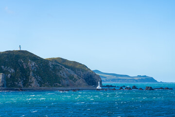 Fototapeta na wymiar Pencarrow Heads lighthouses and coastal scene when leaving Wellington harbour
