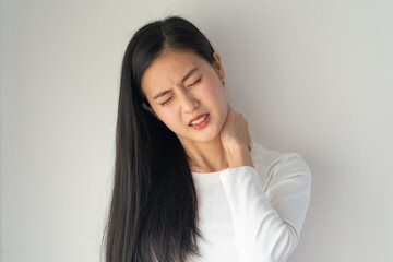 Symptom from Office syndrome, Asian young female rubbing her neck and feeling stiff pain isolated...