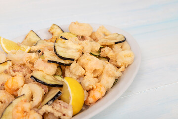 Typical Italian Seafood Fritto Misto di Pesce, Mixed fried fish. Wooden background