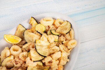 Typical Italian Seafood Fritto Misto di Pesce, Mixed fried fish. Wooden background