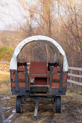 Fototapeta na wymiar Close up view of old covered wagon in the farm