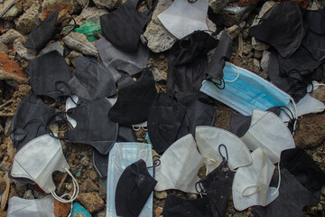 Garbage during COVID-19. Carelessly discarded coronavirus disposable face masks. Environmental and...