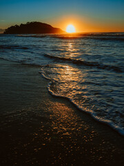 Colorful ocean beach sunrise with deep blue sky and sun rays. - obrazy, fototapety, plakaty